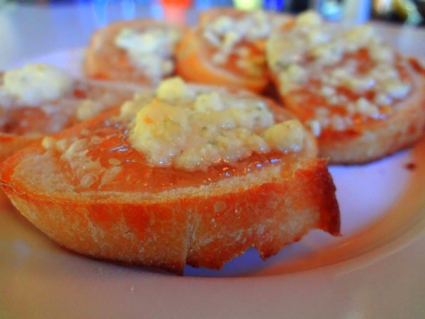 Toasted crostini with mayhaw jelly and gorgonzola cheese